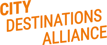 This is a simple text-based logo for "City Destinations Alliance" in bold orange letters. The text appears to be arranged at an upward diagonal angle, creating a dynamic and modern look.