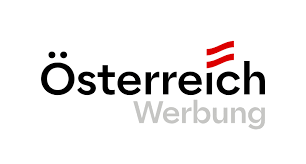 This is a minimalist logo design featuring the word "Österreich" (meaning Austria in German) with the Austrian flag colors represented by two small red stripes above the text. The word "Werbung" (meaning advertising in German) appears below in gray text, making this appear to be a logo for Austrian advertising or marketing services.