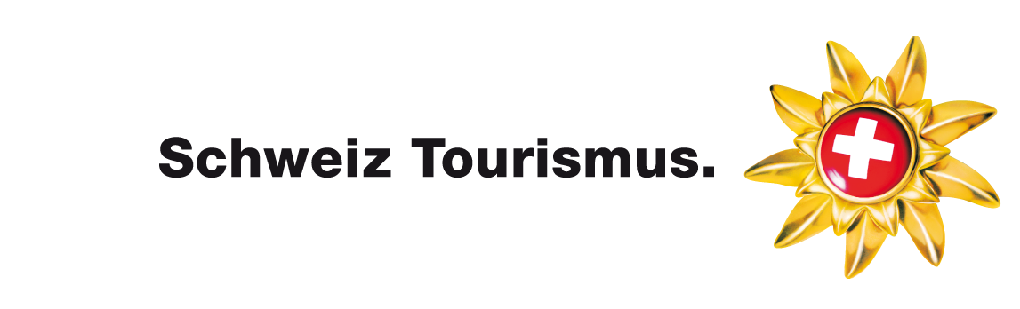 This is the logo for "Schweiz Tourismus" (Switzerland Tourism), the official tourism organization of Switzerland. The logo features bold black text alongside a stylized golden sun or flower emblem containing the iconic Swiss cross in red and white at its center.