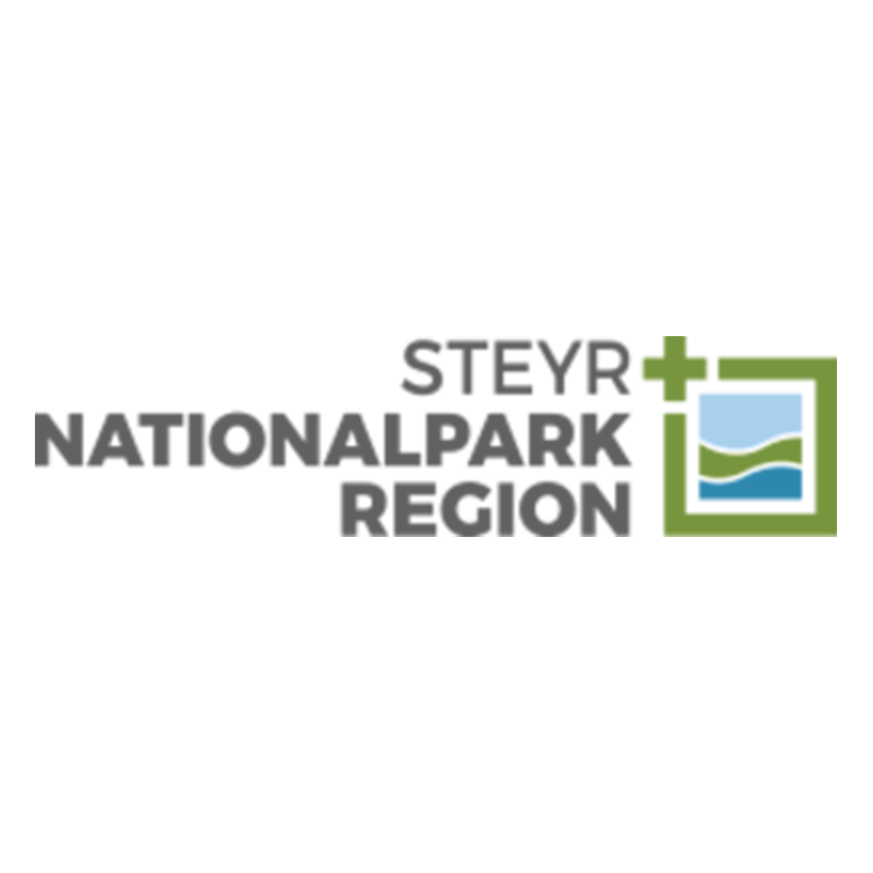 This is the logo for the Steyr National Park Region, featuring text in a modern grey font. The logo includes a minimalist square icon on the right with a green frame and simple blue and green elements that appear to represent sky and landscape.